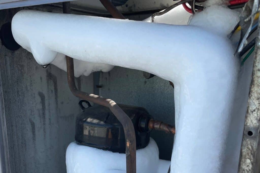 air conditioning unit covered in layer of ice